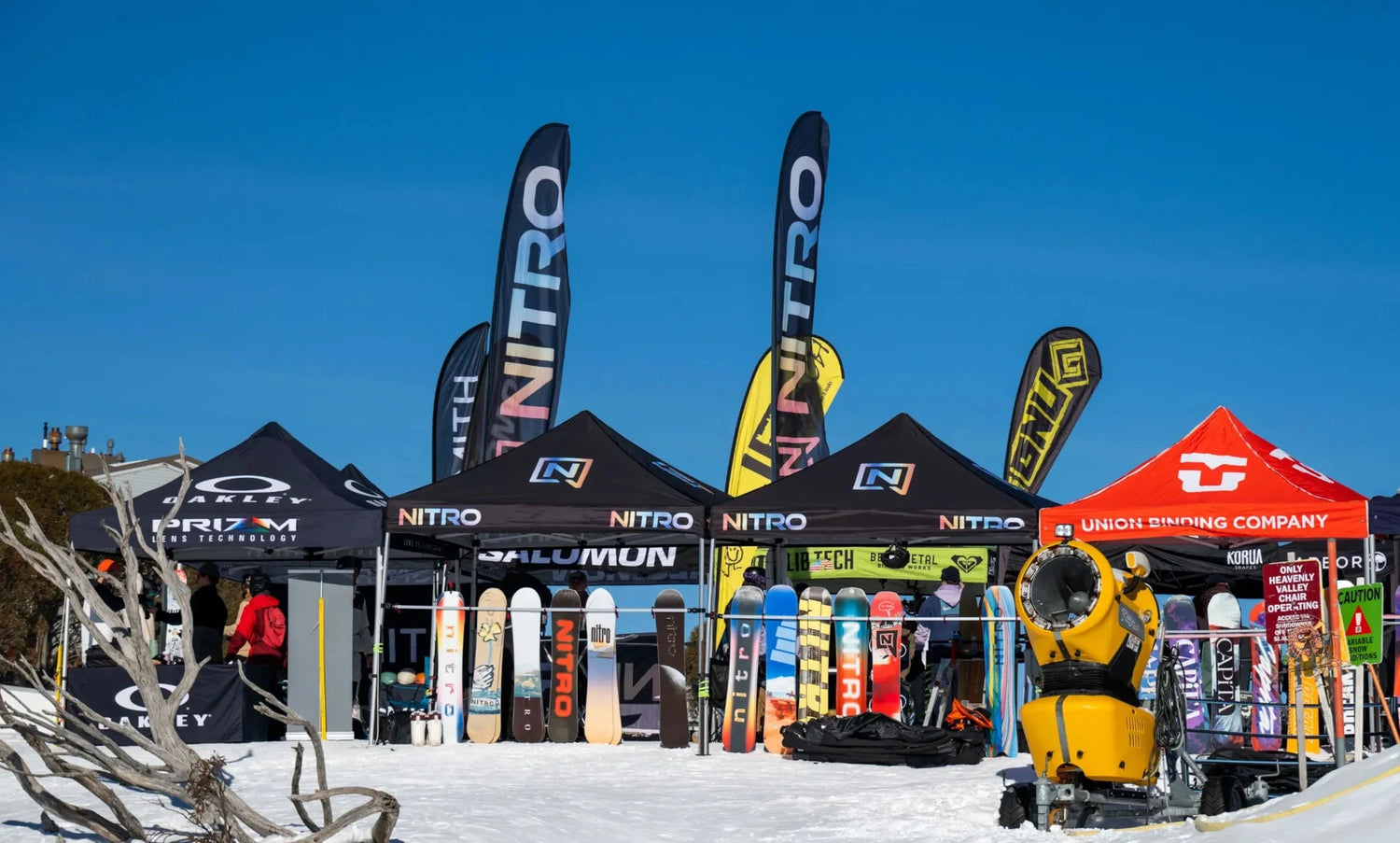 Snowboard and ski equipment display with Nitro branding at a snow sports event.