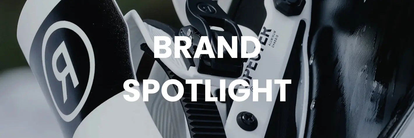 Close-up of a Snowboard binfing with brand logo and text overlay 'BRAND SPOTLIGHT'.