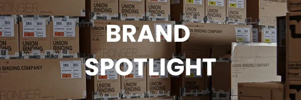 Stack of cardboard boxes with 'Union Binding Company' branding, featuring text overlay 'BRAND SPOTLIGHT'.