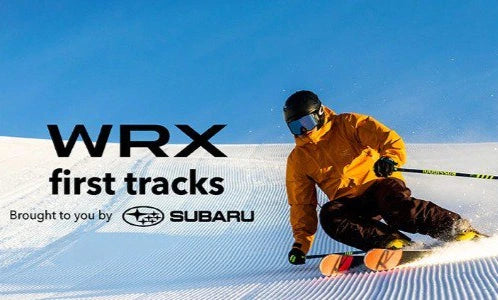 Person skiing with Subaru WRX branding on a blue sky background